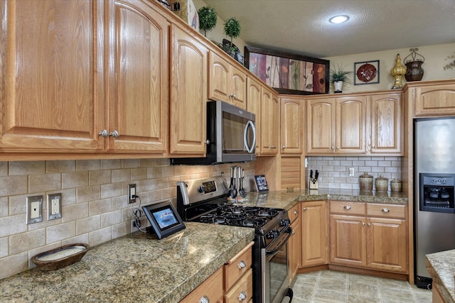 1511 N Lancashire Ln, Liberty Lake, WA 99019 - kitchen with decorative backsplash, stainless steel appliances, a textured ceiling, and tile countertops