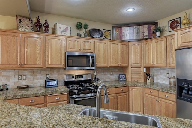 1511 N Lancashire Ln, Liberty Lake, WA 99019 - kitchen featuring decorative backsplash, stainless steel appliances, a sink, and tile countertops