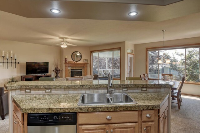 1511 N Lancashire Ln, Liberty Lake, WA 99019 - kitchen with stainless steel dishwasher, light carpet, a sink, open floor plan, and ceiling fan with notable chandelier