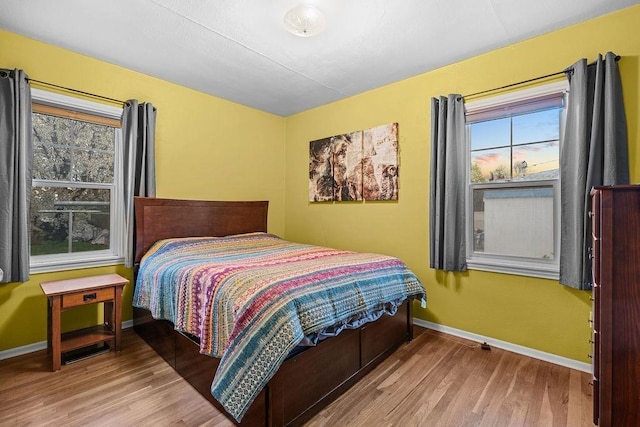 bedroom featuring baseboards and wood finished floors