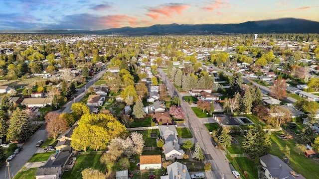 aerial view at dusk with a mountain view and a residential view