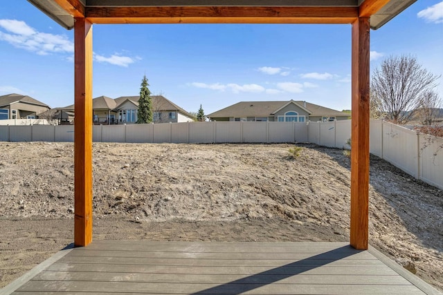 view of yard featuring a fenced backyard and a residential view
