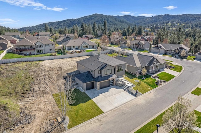 bird's eye view featuring a forest view, a mountain view, and a residential view