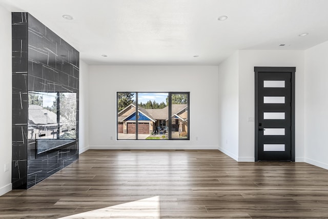 entryway with wood finished floors, recessed lighting, and baseboards