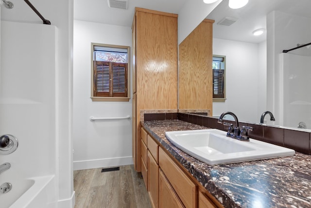 1633 E Northwood Dr, Hayden, ID 83835 - full bath with shower / tub combination, vanity, baseboards, wood finished floors, and visible vents