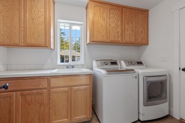 1633 E Northwood Dr, Hayden, ID 83835 - laundry area featuring a sink, separate washer and dryer, and cabinet space