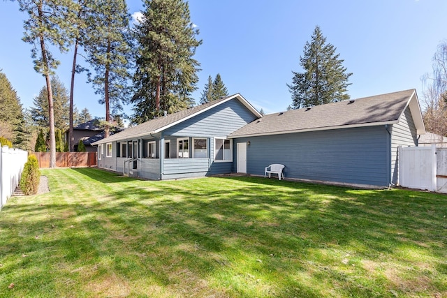 1633 E Northwood Dr, Hayden, ID 83835 - rear view of house with a lawn, a shingled roof, and a fenced backyard