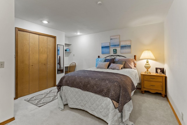 bedroom featuring recessed lighting, baseboards, a closet, and light colored carpet