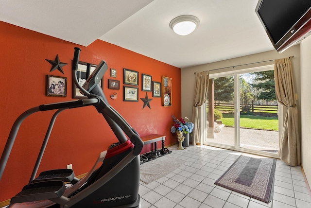 exercise room featuring light tile patterned floors