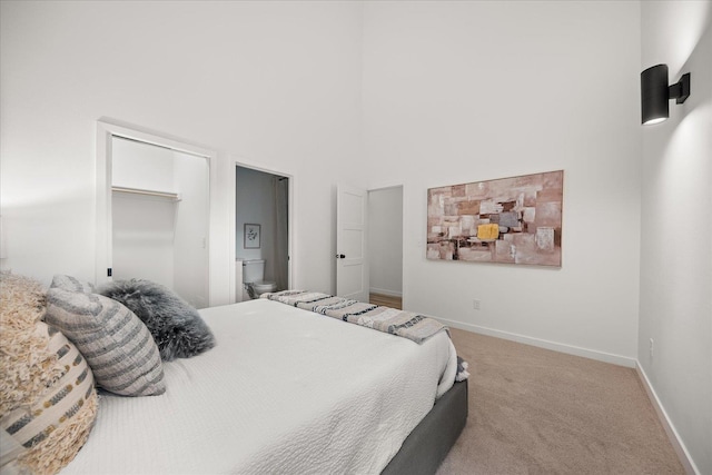 bedroom with carpet floors, a closet, and baseboards