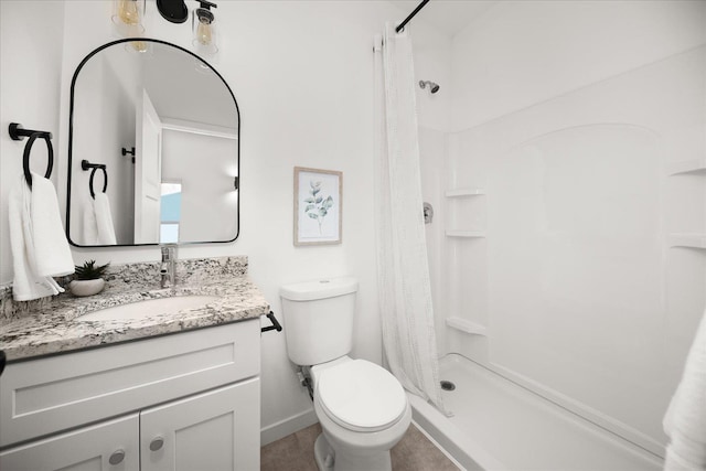 bathroom featuring toilet, baseboards, vanity, and a stall shower
