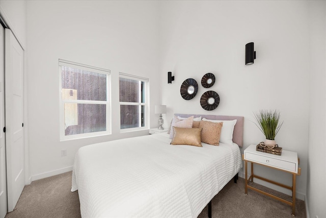 bedroom featuring a closet, carpet flooring, and baseboards