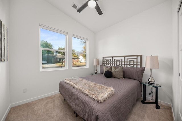 carpeted bedroom with ceiling fan, vaulted ceiling, visible vents, and baseboards