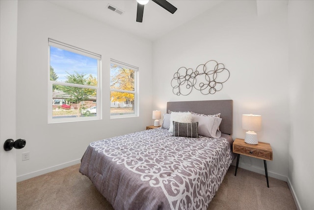 carpeted bedroom with baseboards, a ceiling fan, vaulted ceiling, and visible vents