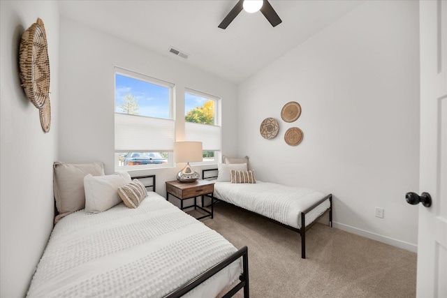 bedroom featuring lofted ceiling, visible vents, a ceiling fan, carpet floors, and baseboards