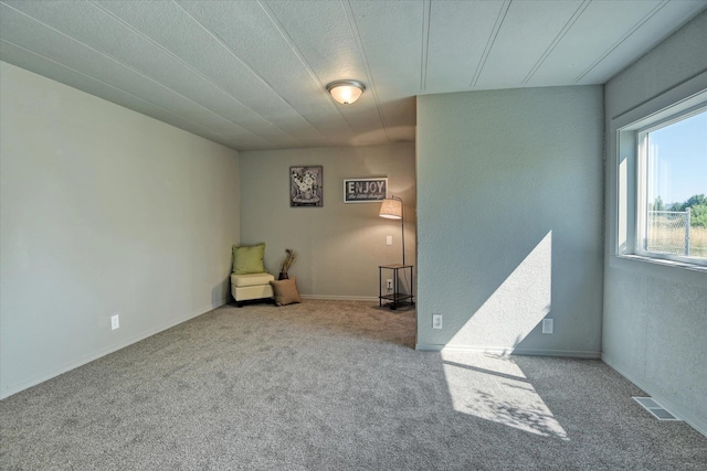 unfurnished room featuring visible vents and carpet flooring