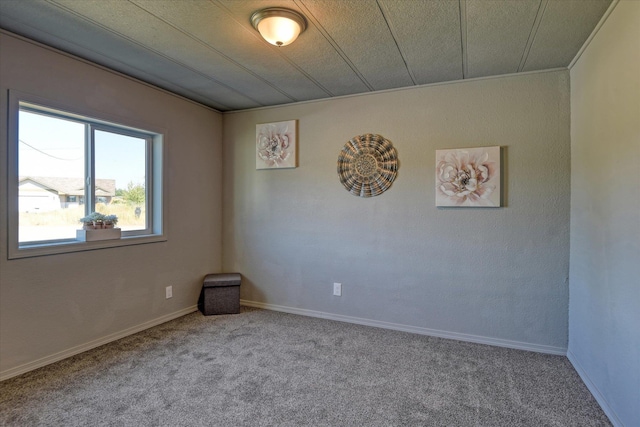 carpeted spare room with baseboards