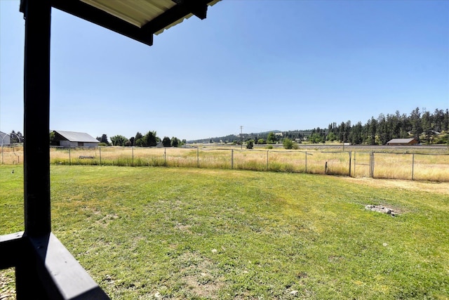 view of yard featuring fence and a rural view