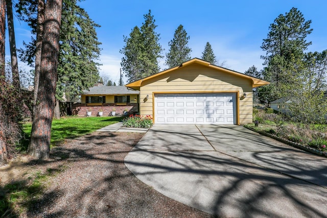 ranch-style house featuring an attached garage and concrete driveway