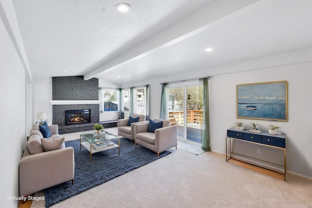 carpeted living room featuring lofted ceiling with beams, baseboards, a fireplace, and recessed lighting