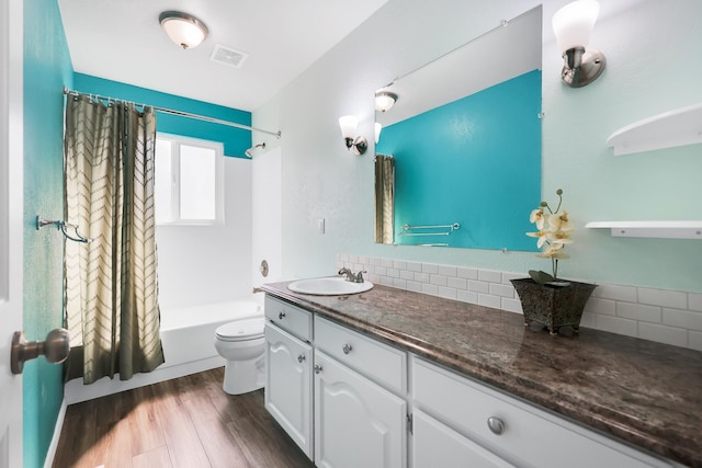 full bathroom with toilet, visible vents, decorative backsplash, wood finished floors, and shower / bath combination with curtain