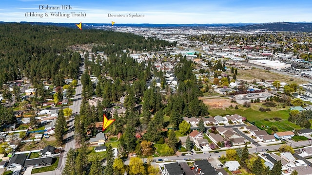 aerial view featuring a forest view and a mountain view