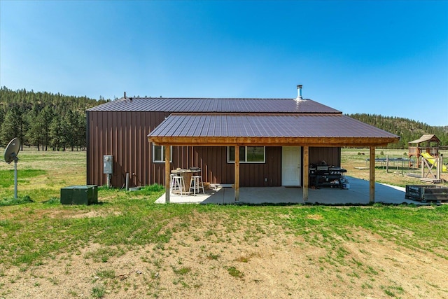40359 Barbara Ln, Davenport, WA 99122 - back of house featuring metal roof, a yard, a patio, and board and batten siding