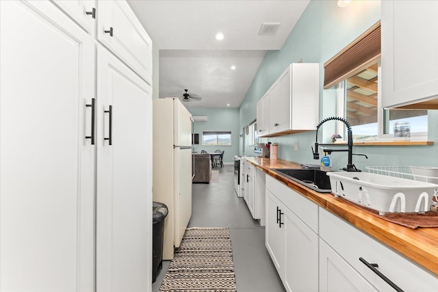 40359 Barbara Ln, Davenport, WA 99122 - kitchen with butcher block countertops, ceiling fan, white cabinetry, visible vents, and freestanding refrigerator