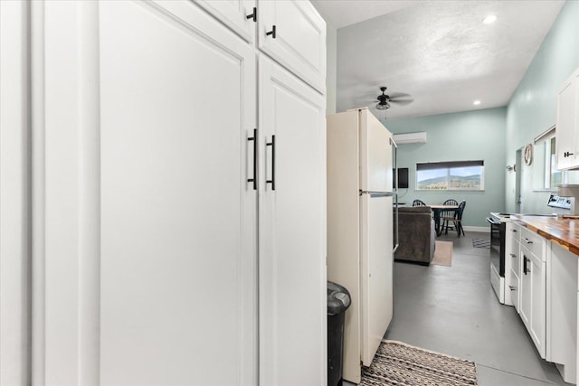 40359 Barbara Ln, Davenport, WA 99122 - kitchen featuring electric stove, wooden counters, ceiling fan, finished concrete flooring, and freestanding refrigerator