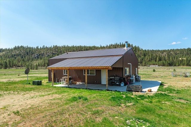 40359 Barbara Ln, Davenport, WA 99122 - rear view of property featuring a yard, a forest view, and metal roof