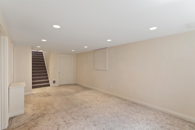finished below grade area with recessed lighting, stairway, visible vents, light carpet, and baseboards