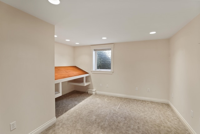 spare room featuring recessed lighting, carpet floors, and baseboards