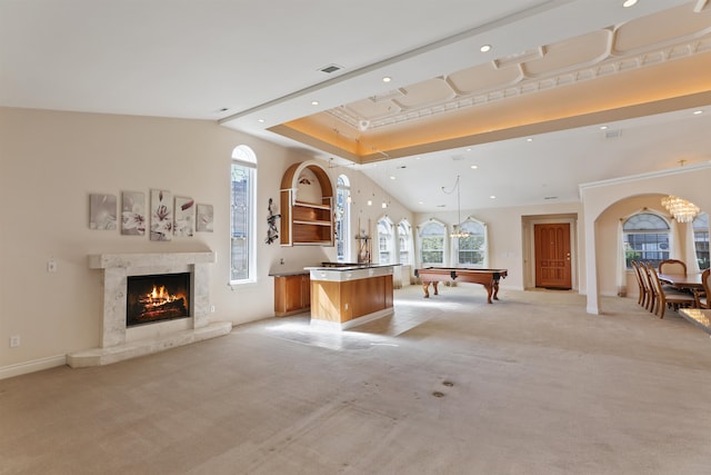 living room with recessed lighting, arched walkways, visible vents, and light carpet