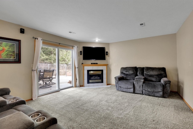 carpeted living room with baseboards, visible vents, and a fireplace