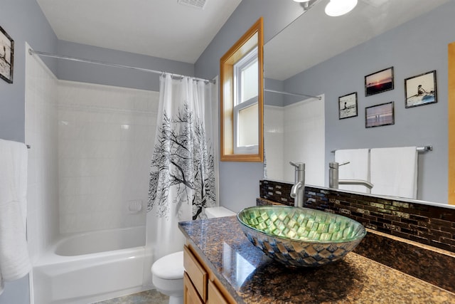 full bath featuring shower / bath combination with curtain, vanity, visible vents, and toilet