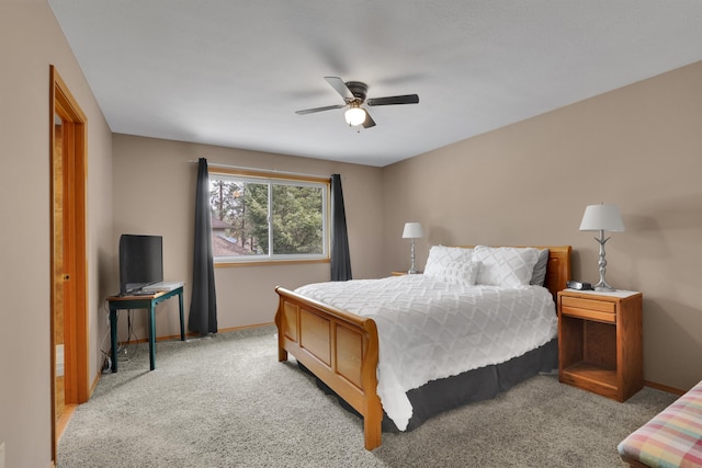 bedroom featuring light carpet, baseboards, and ceiling fan