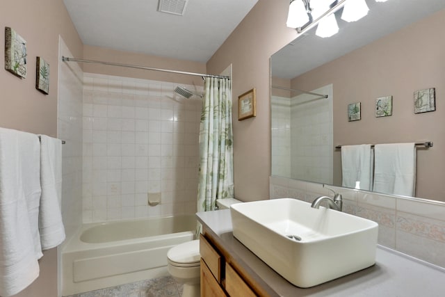 full bath featuring visible vents, toilet, vanity, and shower / bath combination with curtain