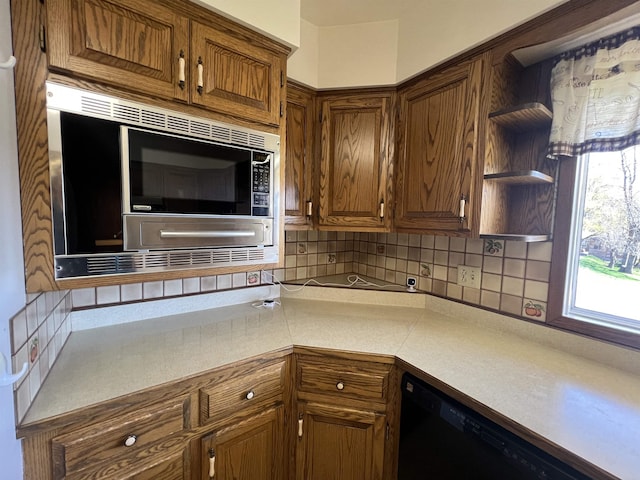 825 N Jefferson St, Colville, WA 99114 - kitchen featuring stainless steel microwave, black dishwasher, decorative backsplash, open shelves, and light countertops