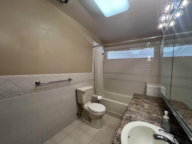 825 N Jefferson St, Colville, WA 99114 - full bathroom with shower / bath combo, wainscoting, tile walls, toilet, and tile patterned flooring