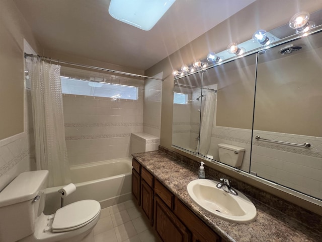 825 N Jefferson St, Colville, WA 99114 - bathroom with tile patterned floors, toilet, tile walls, shower / bath combo with shower curtain, and vanity