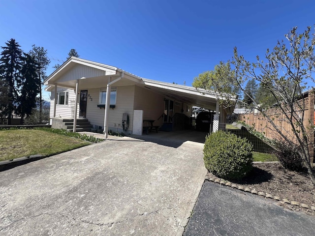 825 N Jefferson St, Colville, WA 99114 - manufactured / mobile home with fence, a carport, and concrete driveway