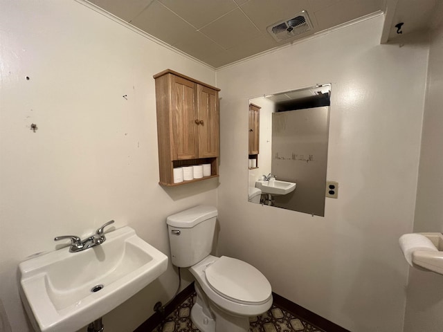 825 N Jefferson St, Colville, WA 99114 - half bath with toilet, a sink, visible vents, and baseboards