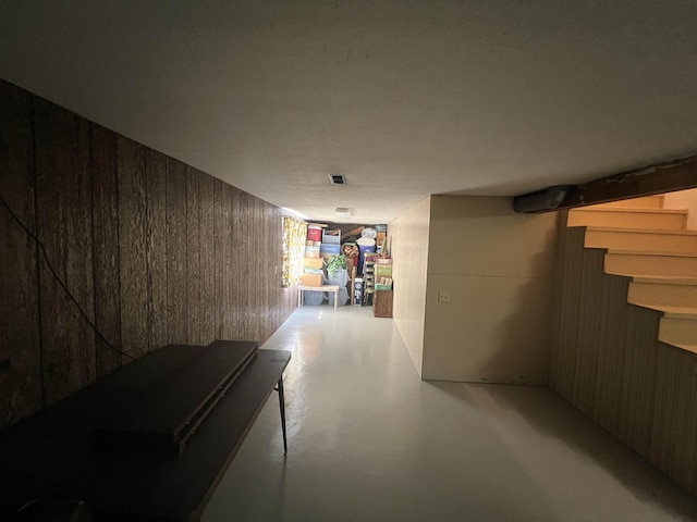 825 N Jefferson St, Colville, WA 99114 - hallway with stairway, wood walls, and finished concrete floors