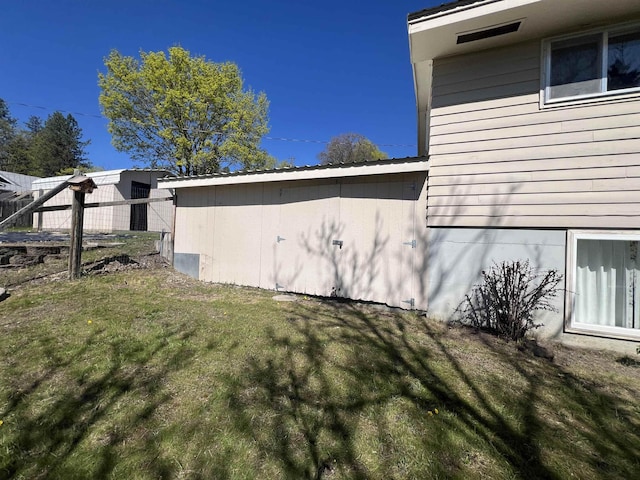 825 N Jefferson St, Colville, WA 99114 - view of side of home featuring fence and a lawn