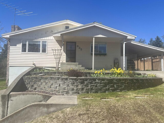 825 N Jefferson St, Colville, WA 99114 - view of front of home featuring a carport, driveway, and a chimney