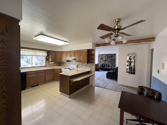 825 N Jefferson St, Colville, WA 99114 - kitchen with white range with electric stovetop, light countertops, open shelves, a ceiling fan, and a peninsula