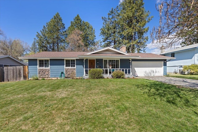 ranch-style home featuring an attached garage, fence, a porch, and a front yard