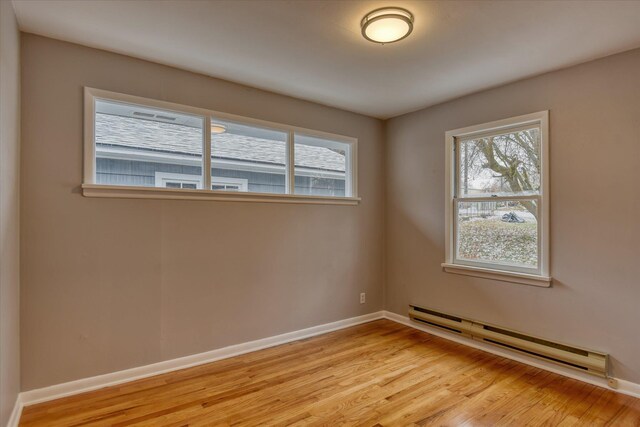 403 W Chestnut St, Almira, WA 99103 - spare room with a baseboard heating unit, light wood finished floors, and healthy amount of natural light