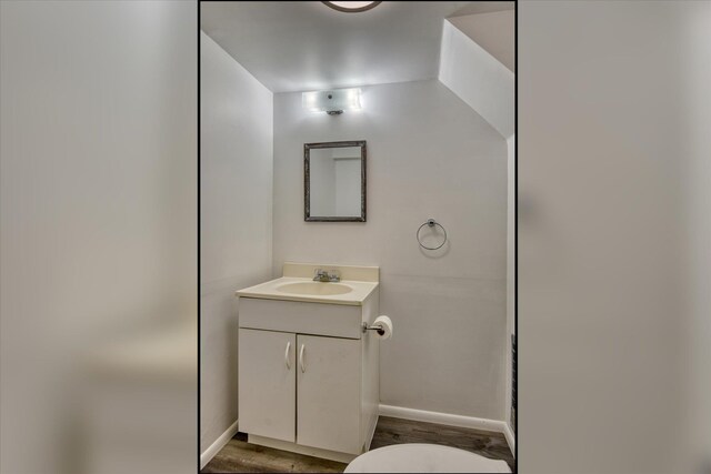 403 W Chestnut St, Almira, WA 99103 - half bathroom featuring vanity, wood finished floors, baseboards, and toilet