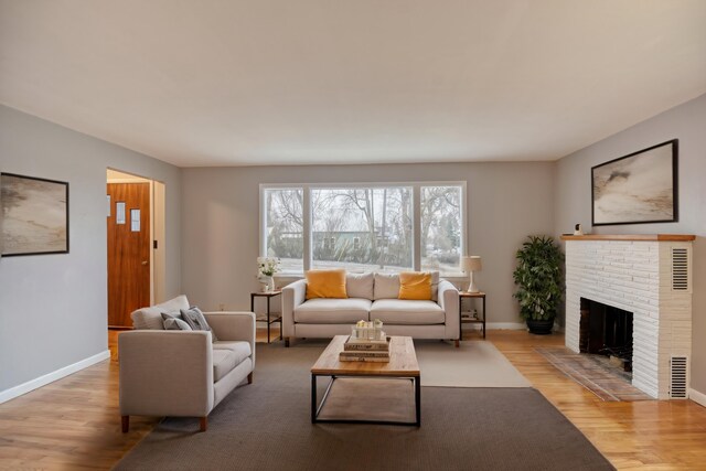 403 W Chestnut St, Almira, WA 99103 - living room with wood finished floors, baseboards, and a brick fireplace